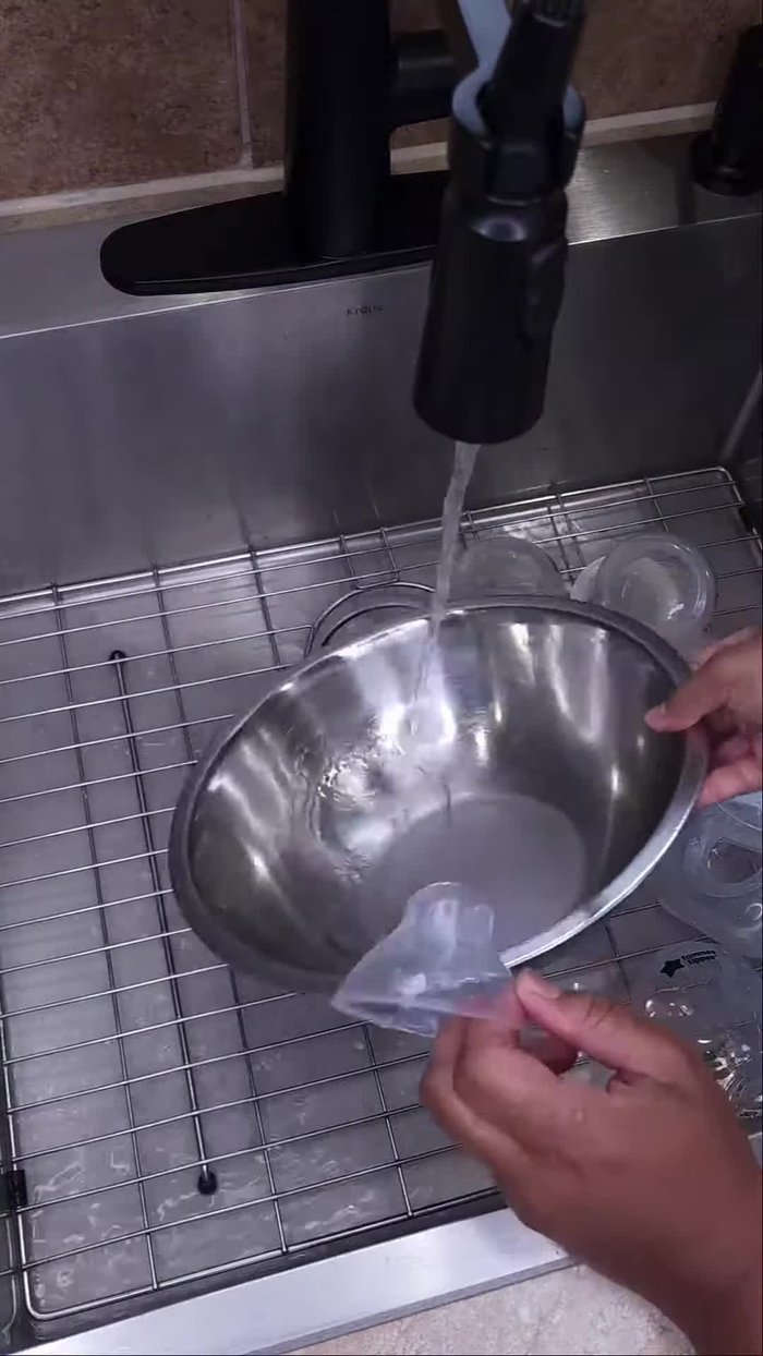 Disassemble baby bottles and rinse each part under warm water.