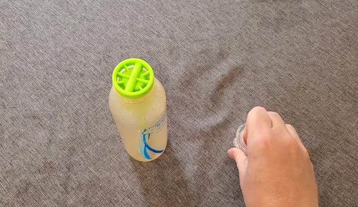 Place the ring on the bottle, ensuring it's properly oriented.