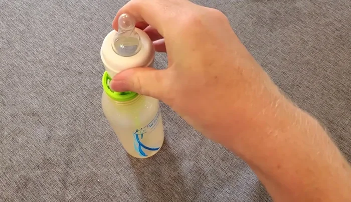 Place the assembled top onto the bottle.