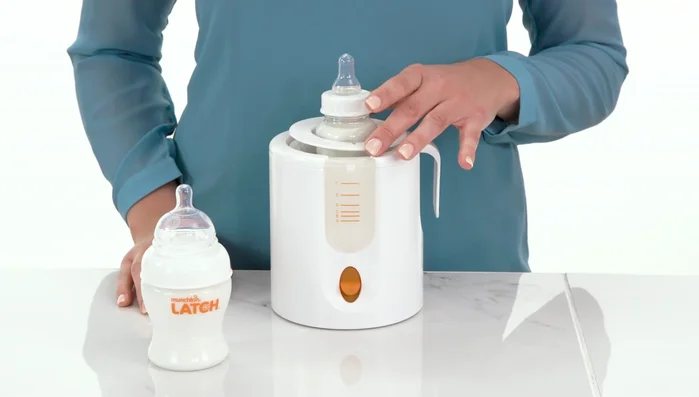 Place the bottle into the basket. Use the adapter ring to cover any gaps around the bottle for even warming (if necessary).