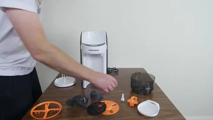 Adjust the powder setting on the machine to the number obtained from the website. Add formula to the container, ensuring it does not exceed the maximum line.