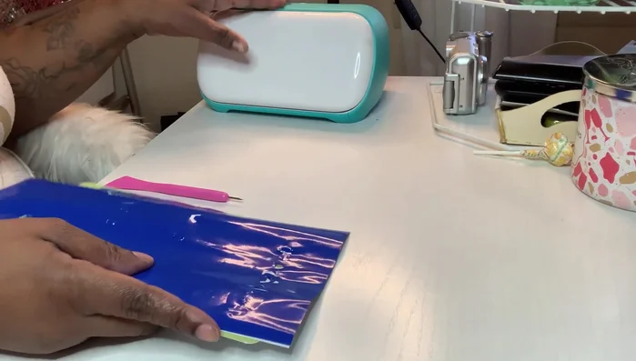 Prepare your design elements. Cut out your desired images and text using a Cricut machine or by hand.