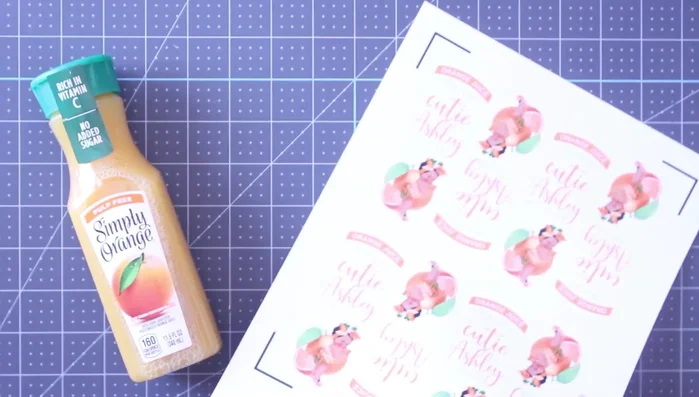 Peel and apply your personalized labels to your orange juice bottles.