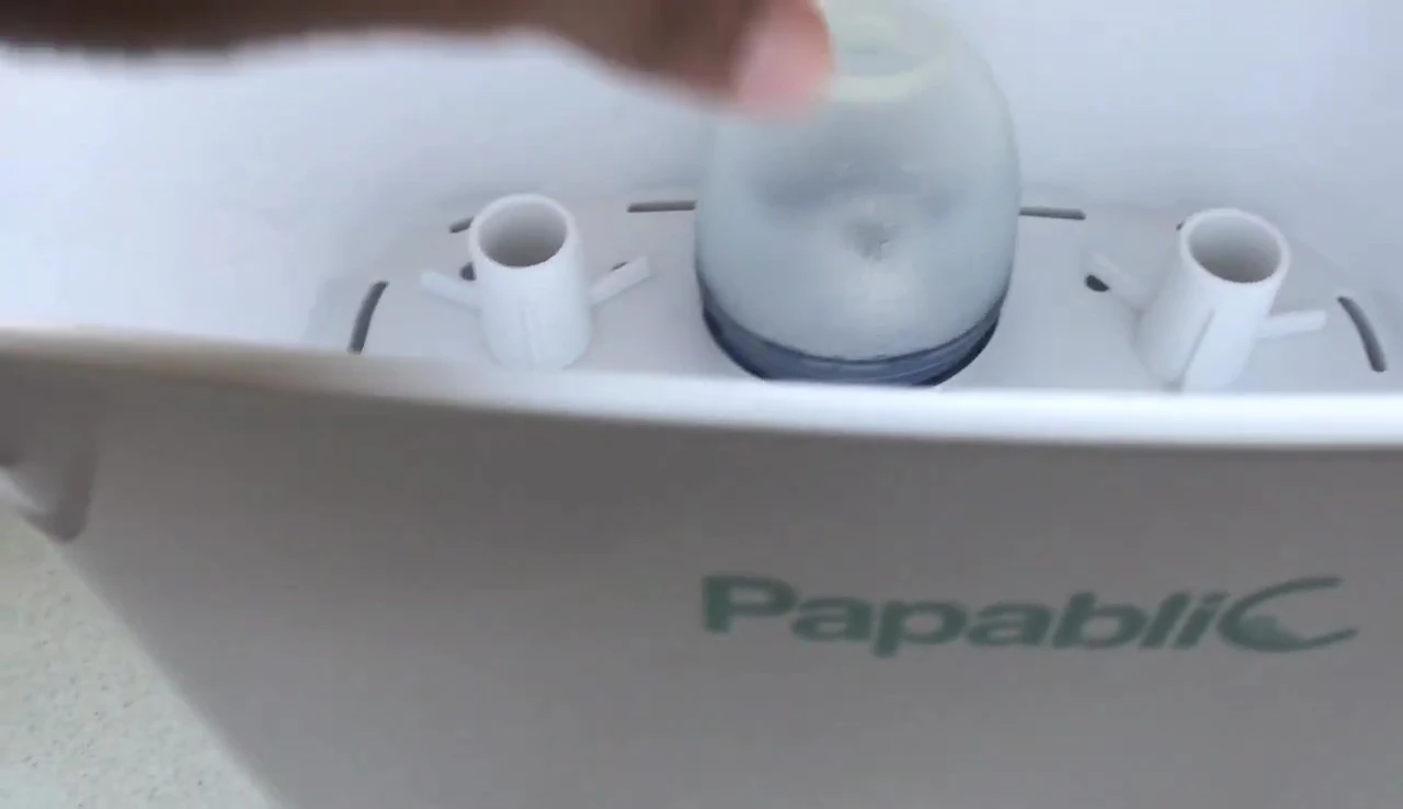 Demonstration of the bottle placement inside the sterilizer.