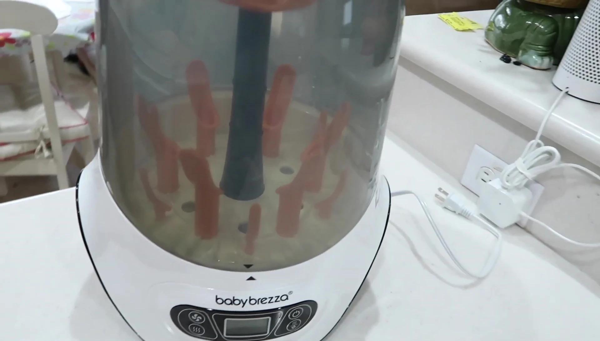 Close-up of the Baby Brezza Bottle Sterilizer, showing its exterior design and control panel.