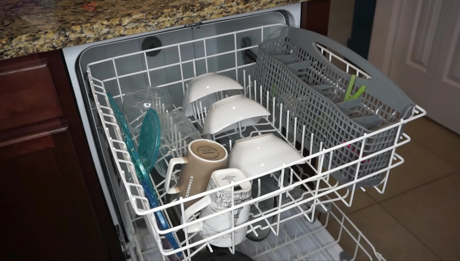 Shot of baby bottles secured in the top rack of a dishwasher.