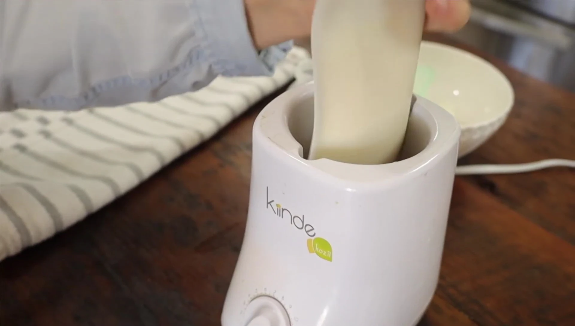 Warming the Junobie bag in a bottle warmer.