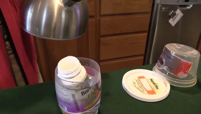 Soak the container in boiling water for a few minutes.