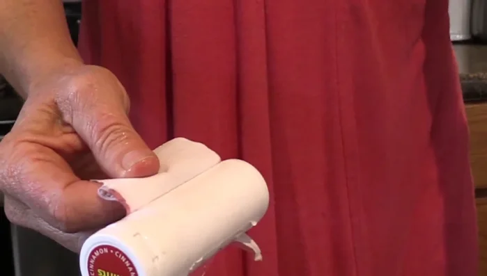 Use a scrub brush to remove any remaining adhesive after removing the label.