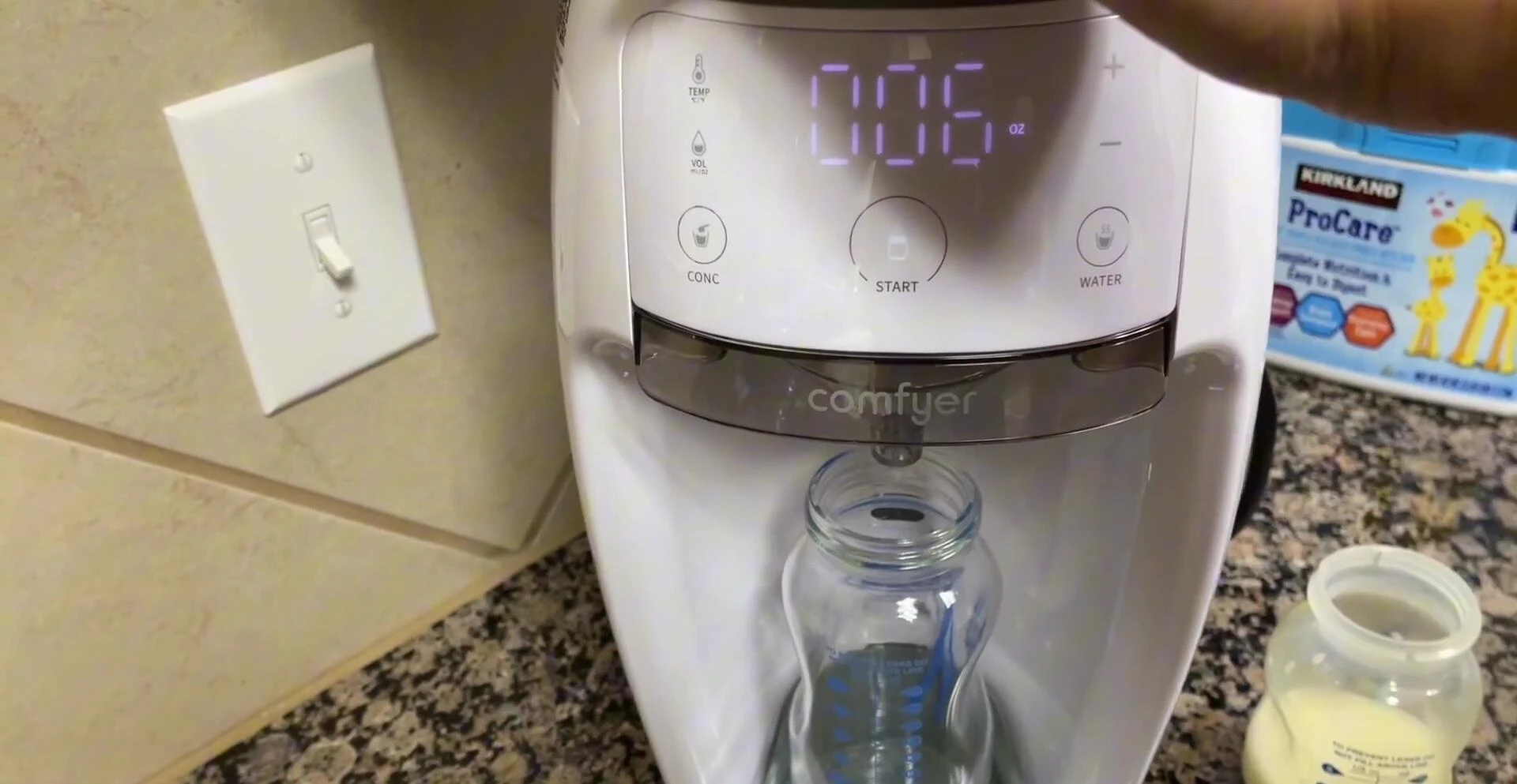 Formula being dispensed into the bottle