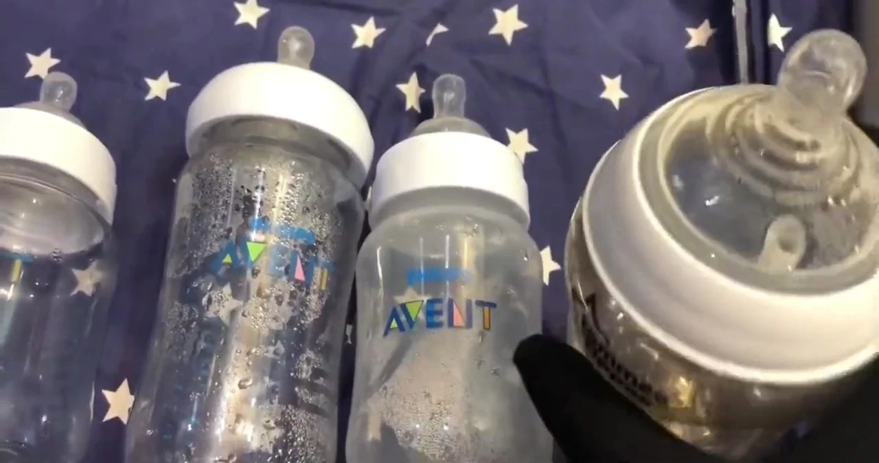 Hand holding the Tommee Tippee bottle.