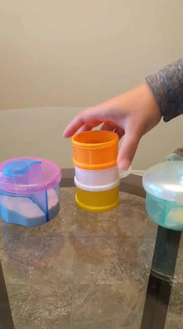 A parent demonstrating the ease of use of a single-layered formula dispenser.