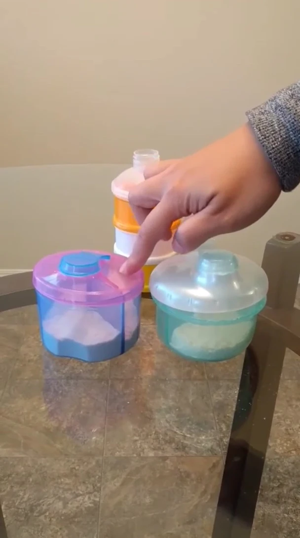 The Munchkin formula dispenser with pink/purple lid.