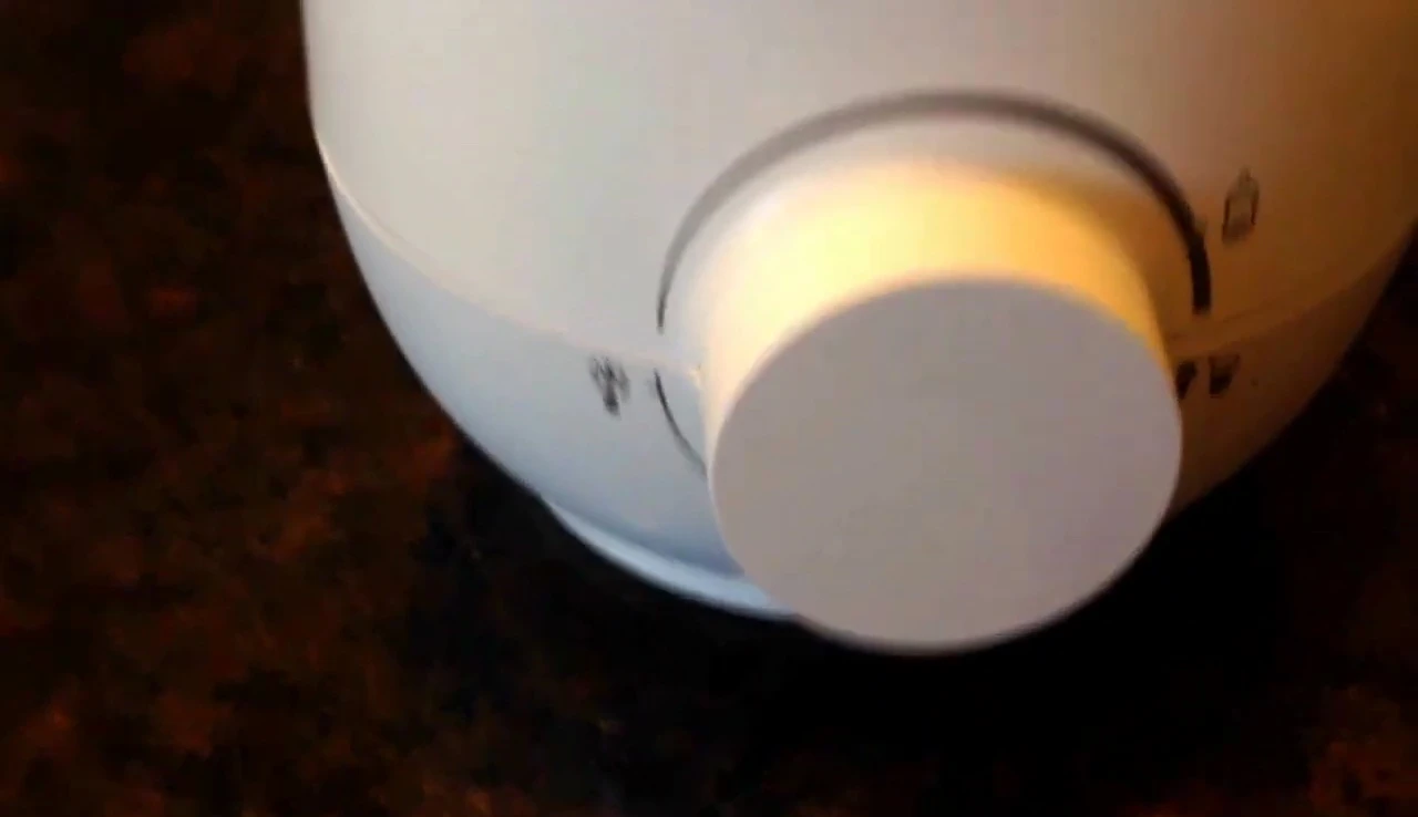 The warmer's control panel with the defrost function illuminated.