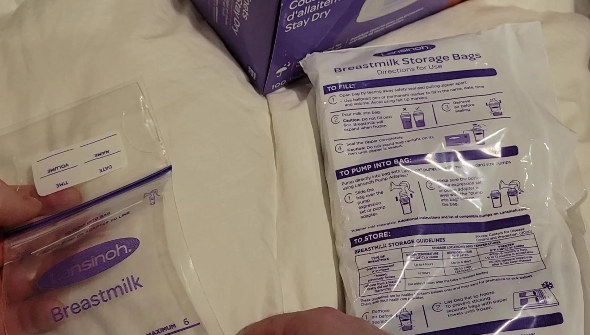 Showing the bag being attached to a breast pump.