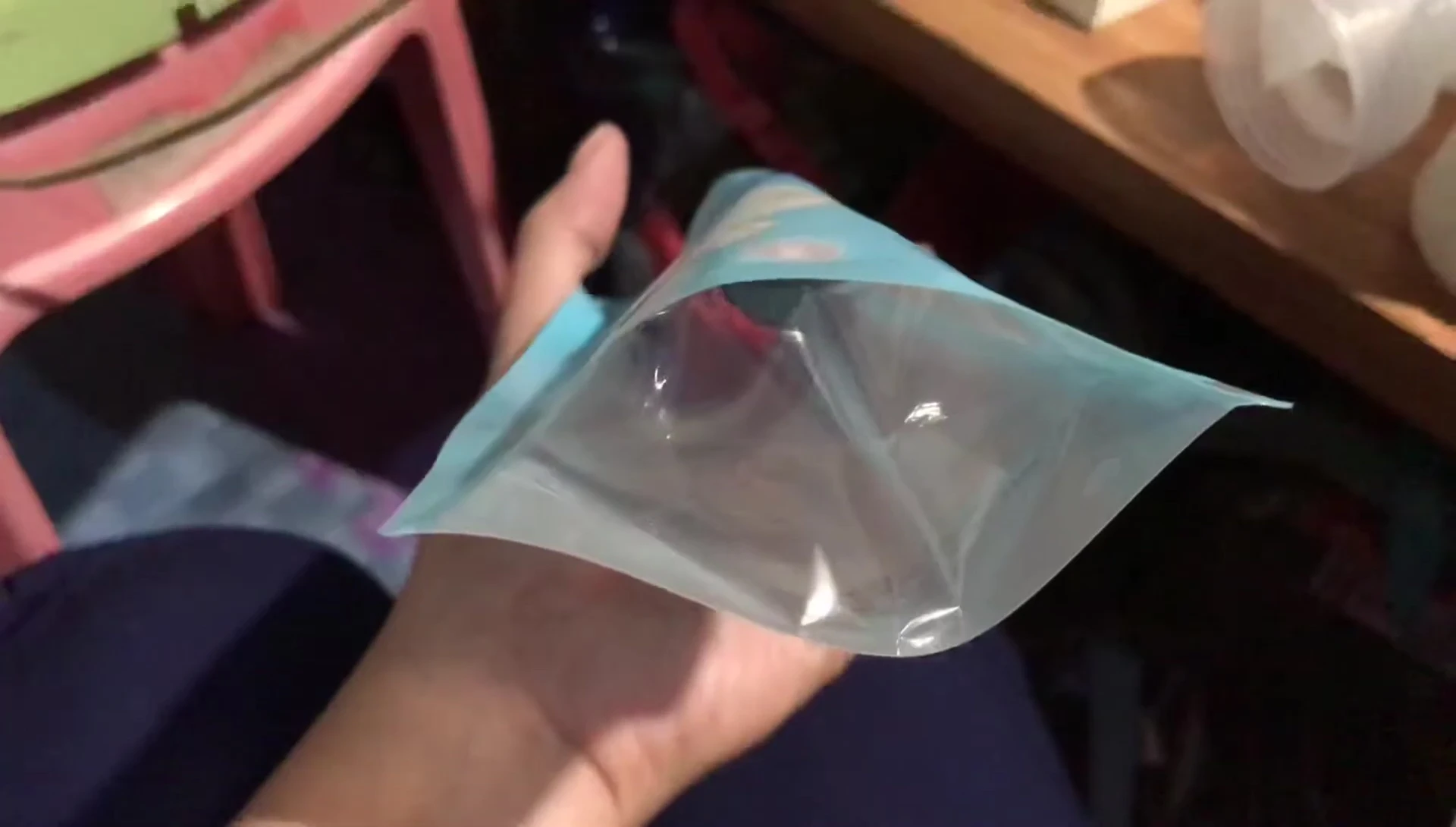 Transferring breast milk into a Dr. Dudu storage bag.