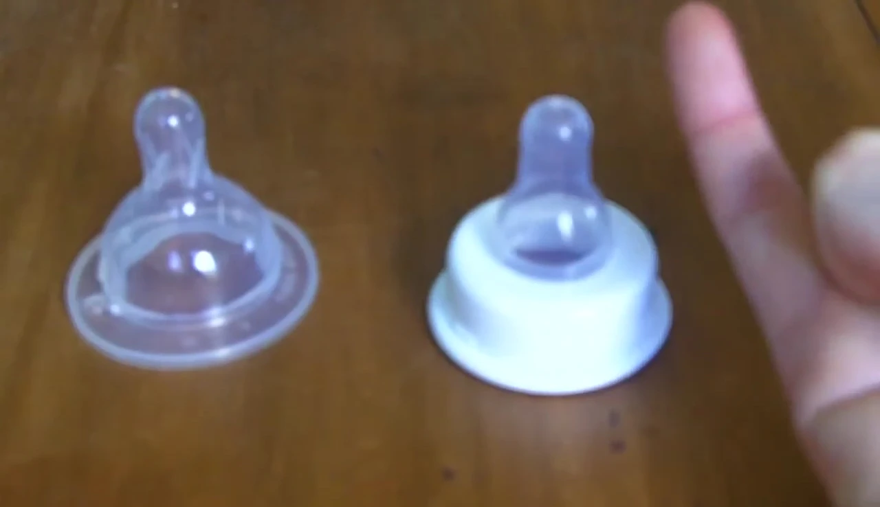 A demonstration showing how far back the teat should be placed in the baby's mouth.