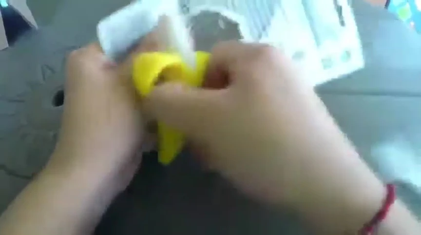 Hand holding the Baby Banana toothbrush, showcasing its flexibility