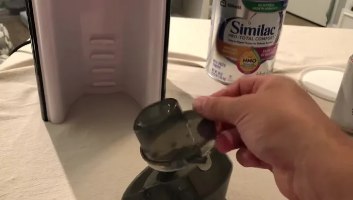 Insert the cleaned dispensing piece, ensuring it clicks into place.