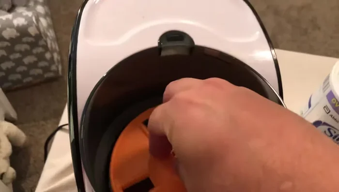 Slide the orange mixing piece into the base.