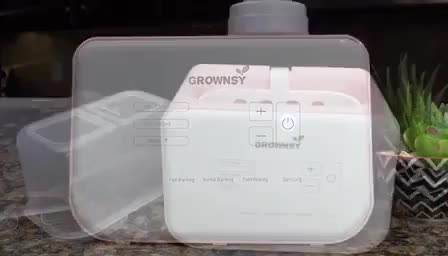 Close-up of the warmer with a bottle inside, highlighting its size.