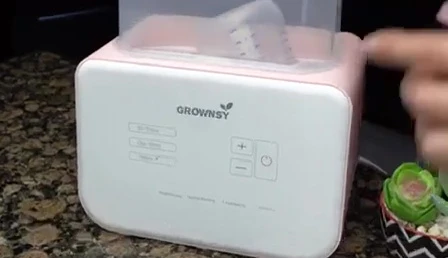 The warmer with bottles showing sterilization mode selected.