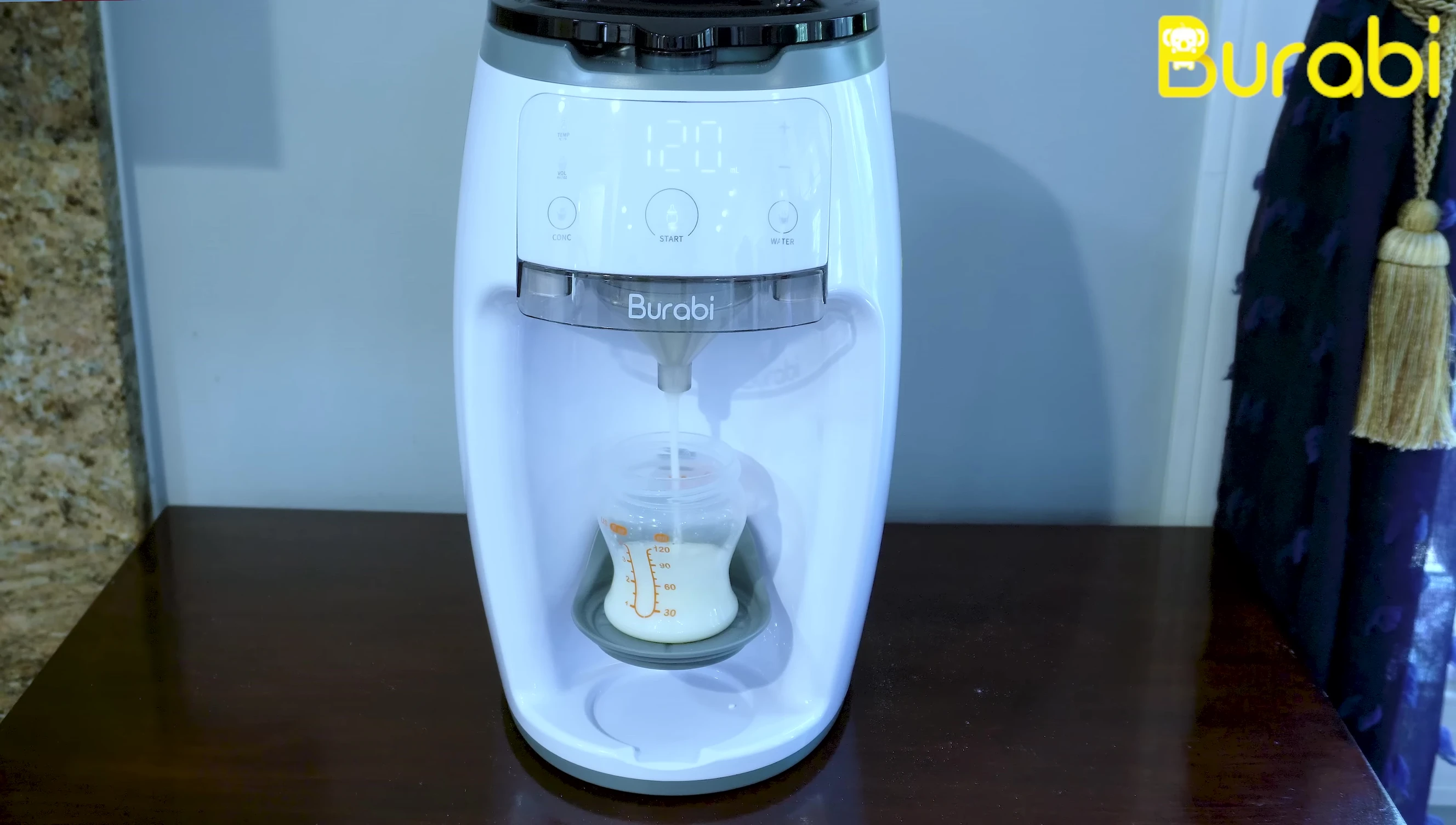 Placing a bottle on the Burabi Formula Maker tray