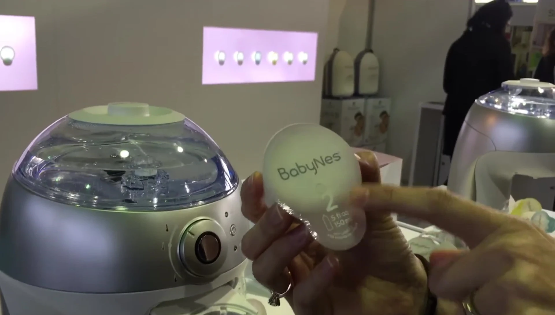 Person selecting a month-two capsule.