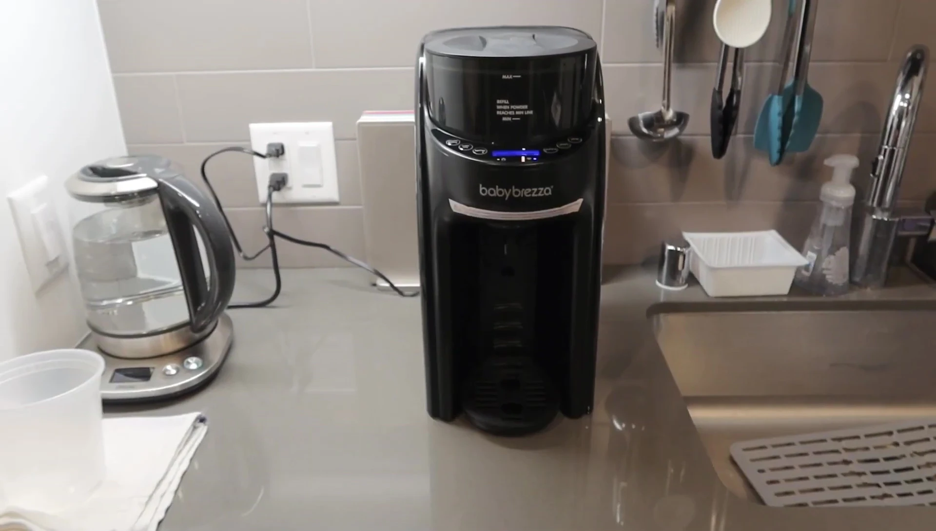 The Baby Brezza Formula Pro Advanced WiFi on a table, showing the display screen.