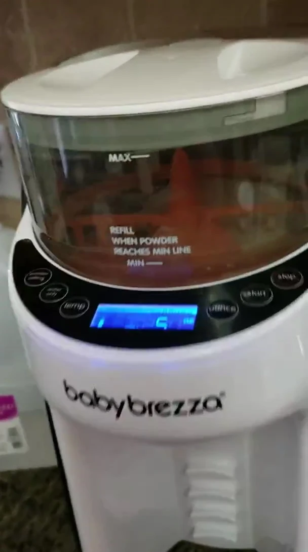 The speaker is demonstrating the cleaning of the Baby Brezza.