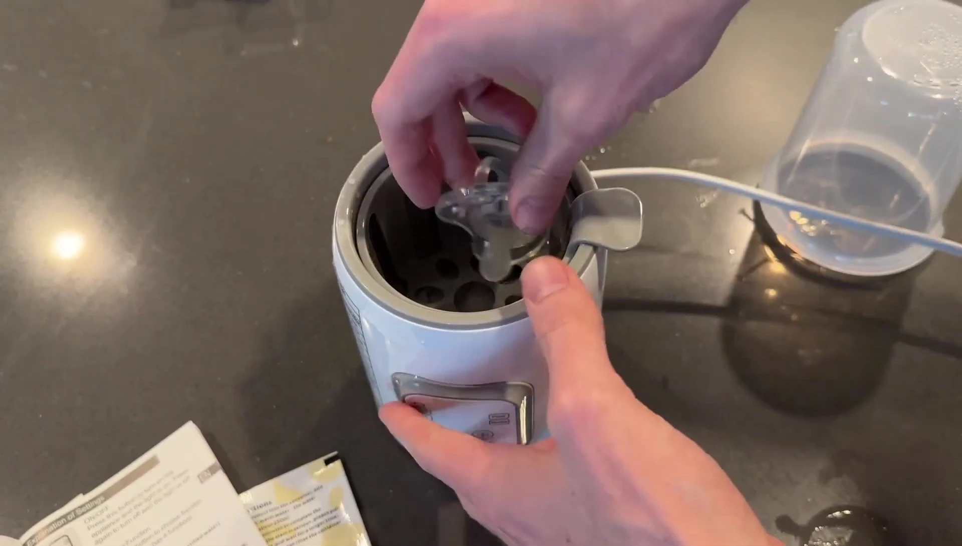Placing a pacifier in the warmer for sterilization