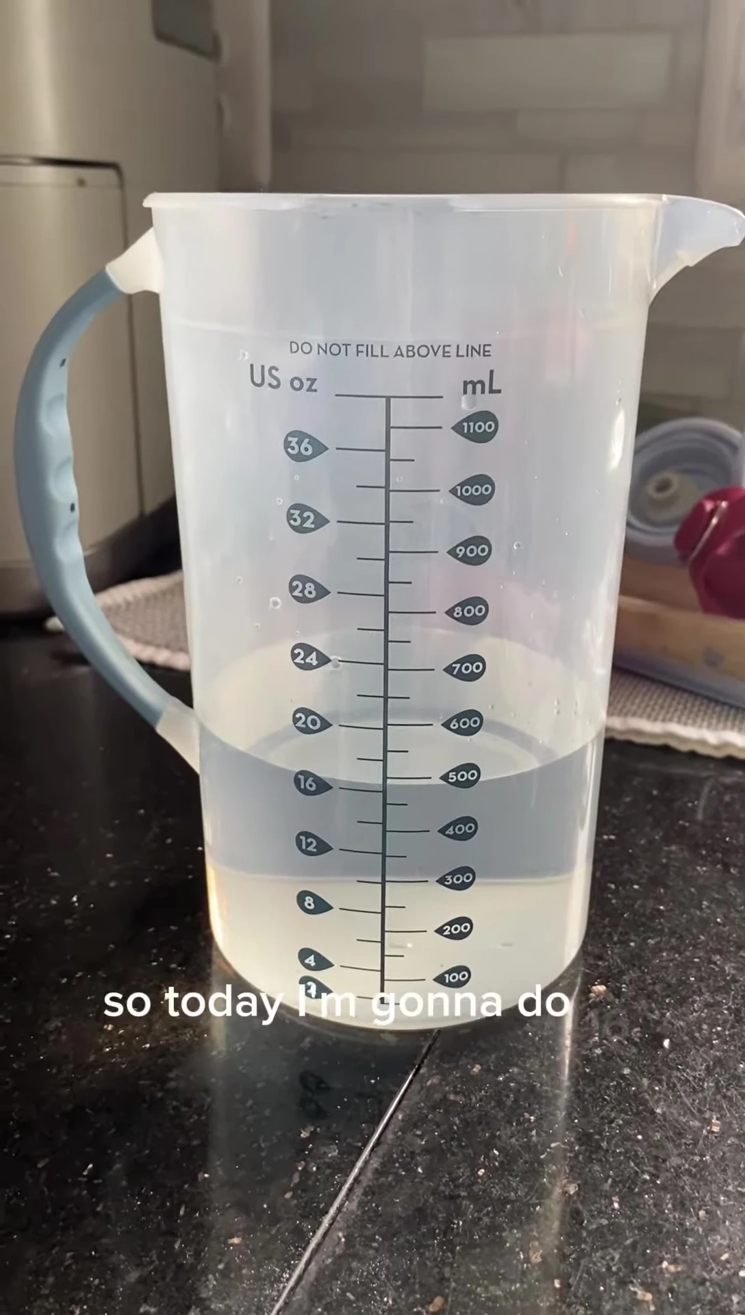 Adding water to the Dr. Brown's Formula Mixer.