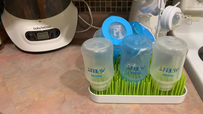 Clean the bottles with dish soap and a baby bottle brush.