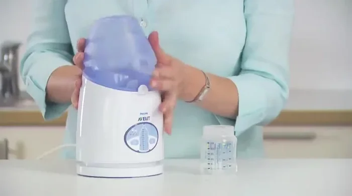 Unplug the warmer and empty any residual water. Clean with a damp cloth. To remove the lifter, push the handle away, rotate a quarter turn, and lift out.