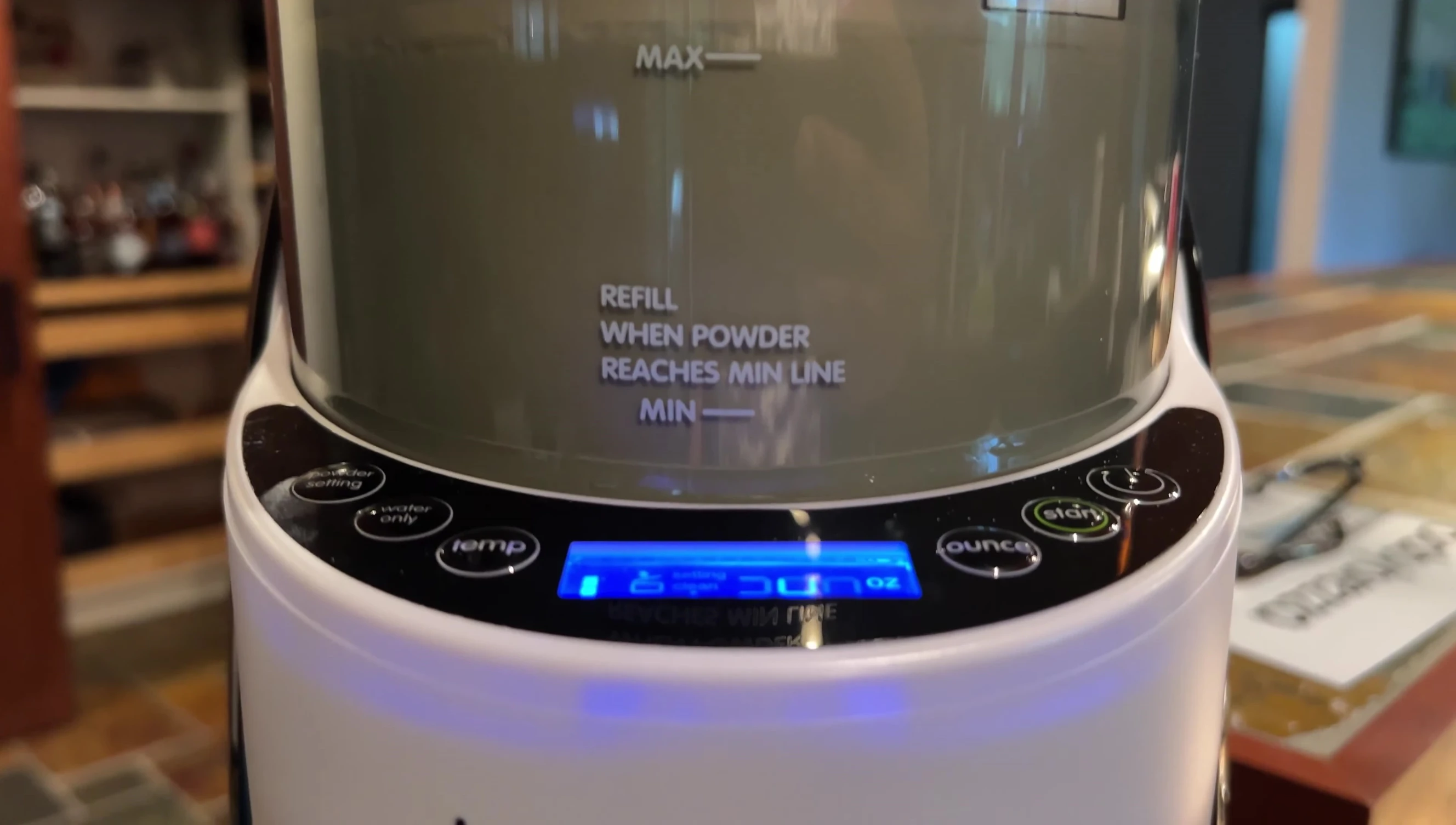 A baby happily drinking formula from the Baby Brezza.
