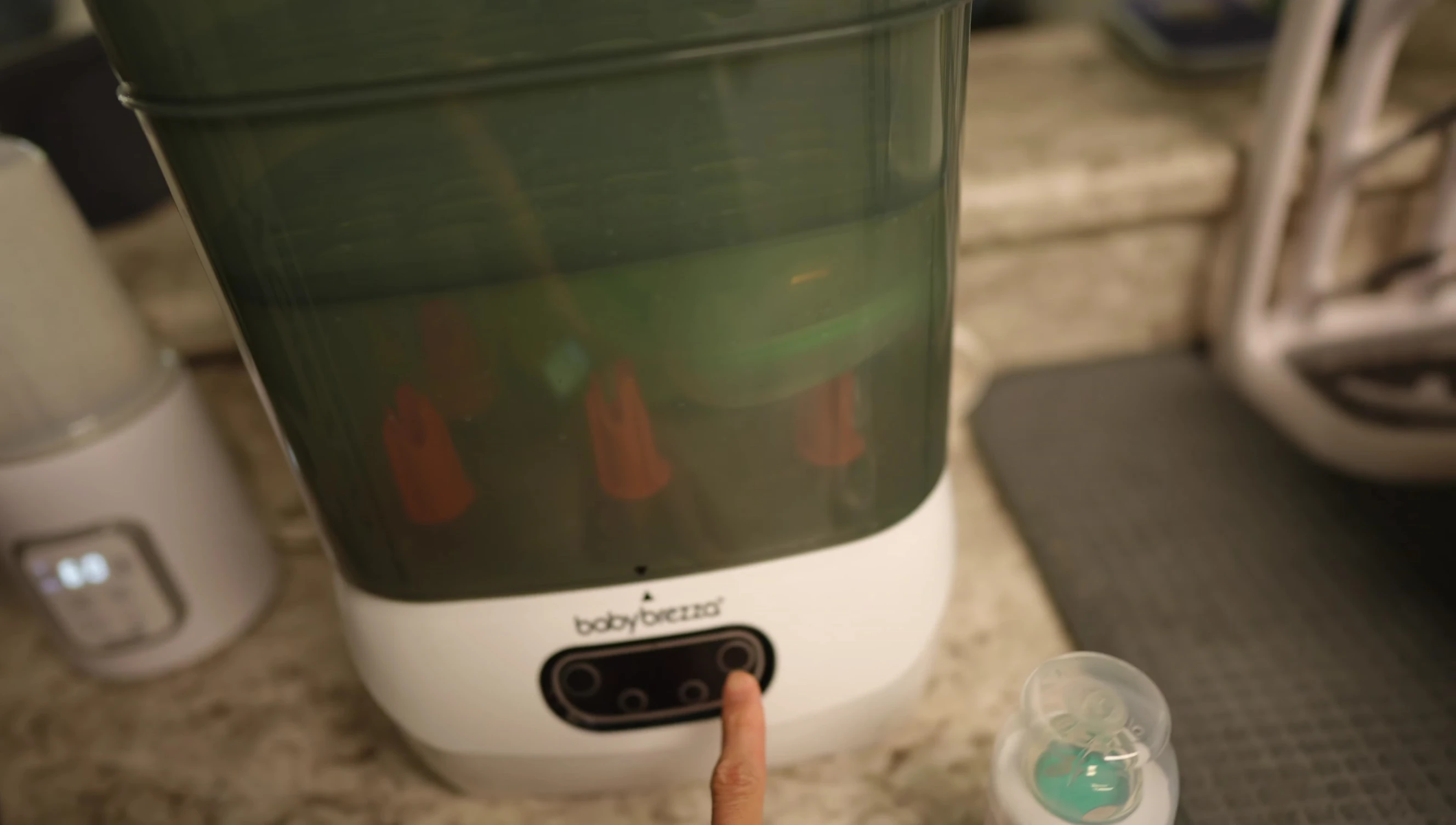 The reviewer demonstrating the power button and timer controls.