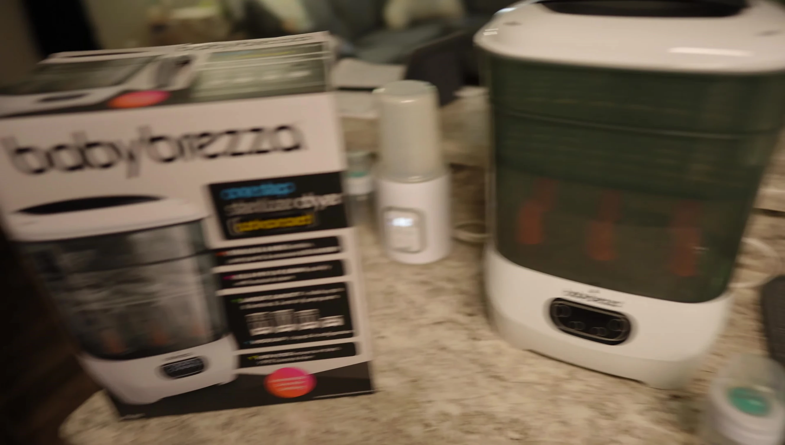 The reviewer holding the Baby Brezza Bottle Dryer.