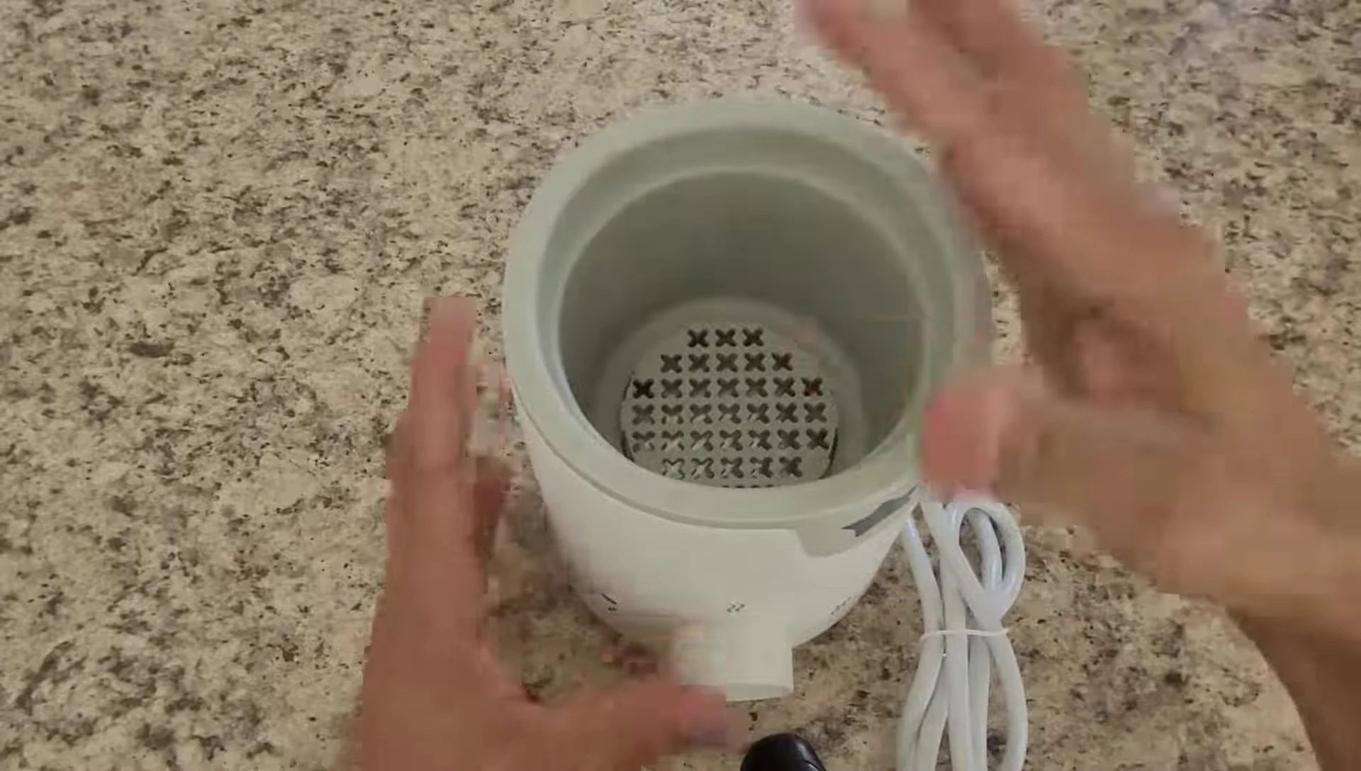 Close-up shot showing the water reservoir and buttons.