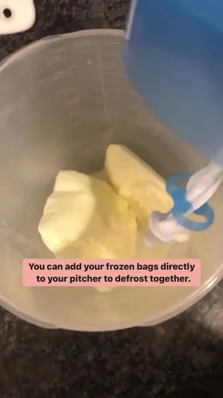 Frozen milk bags being poured into a pitcher.
