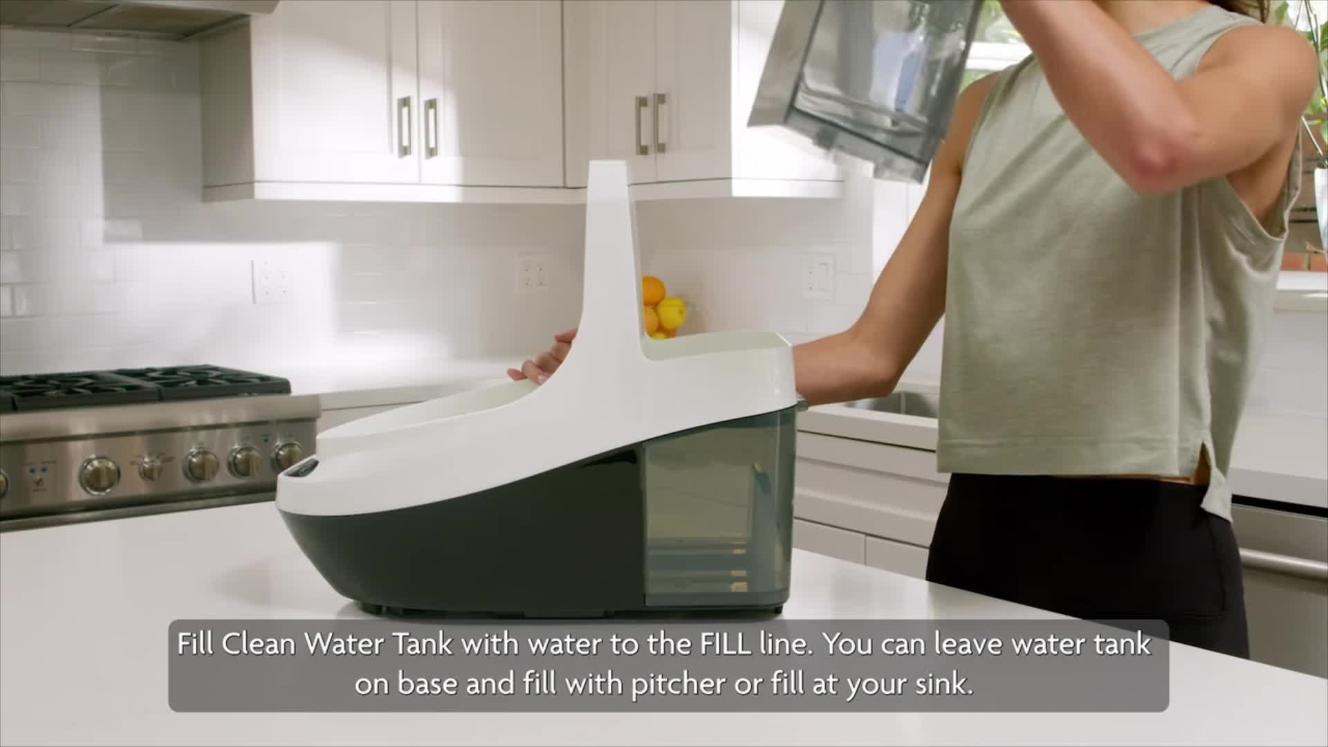 Filling the clean water tank of the Baby Brezza Bottle Washer Pro.