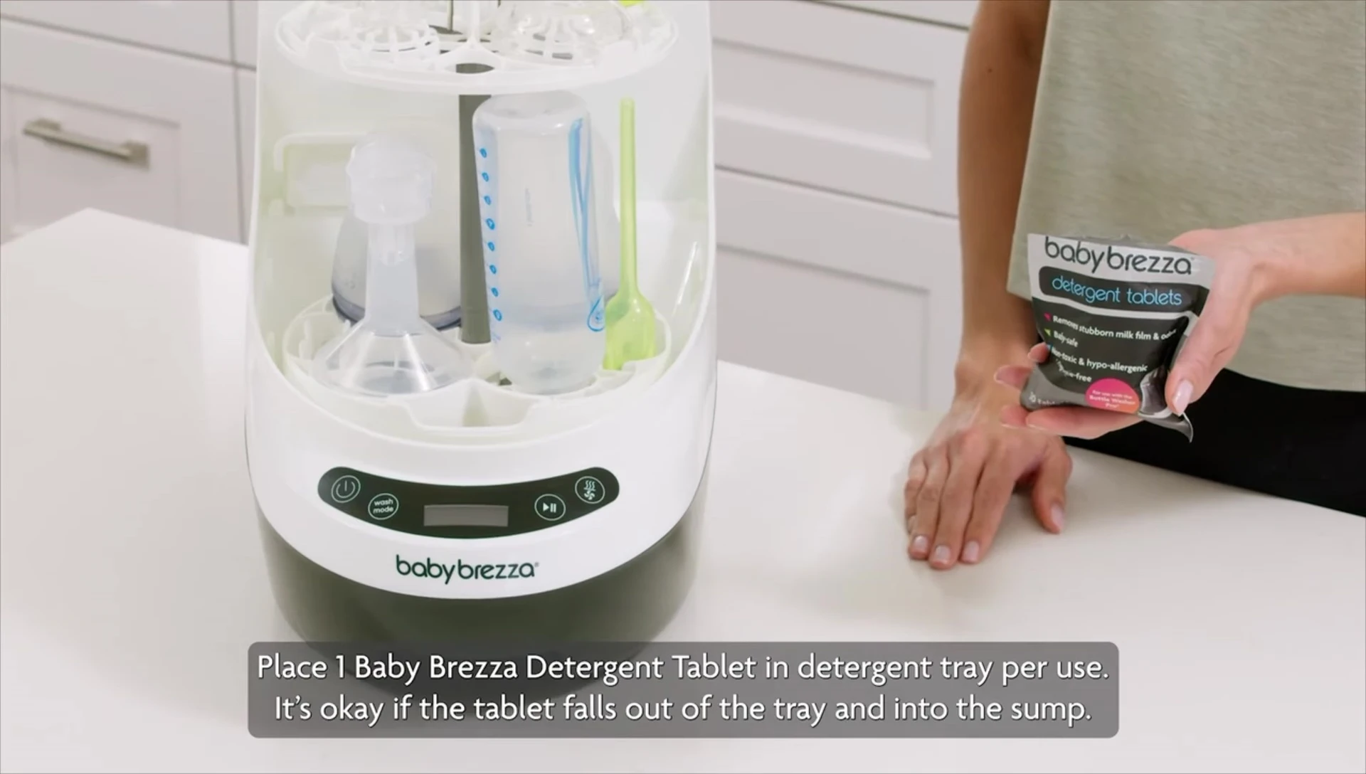 Placing a detergent tablet in the tray.
