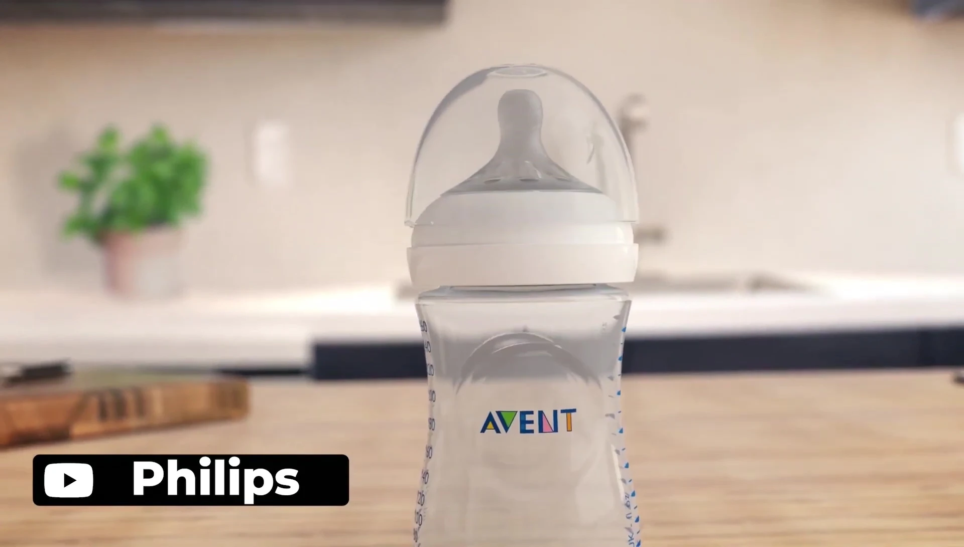 A hand holding the Philips Avent bottle.