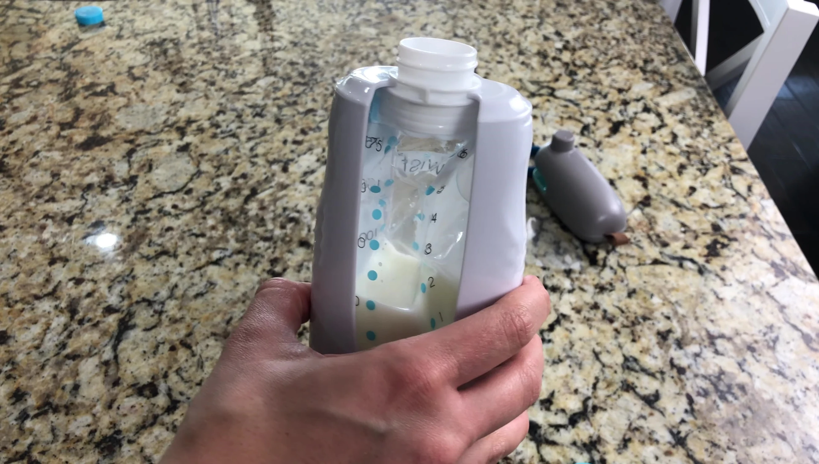 Attaching the nipple to the Kiinde bottle.