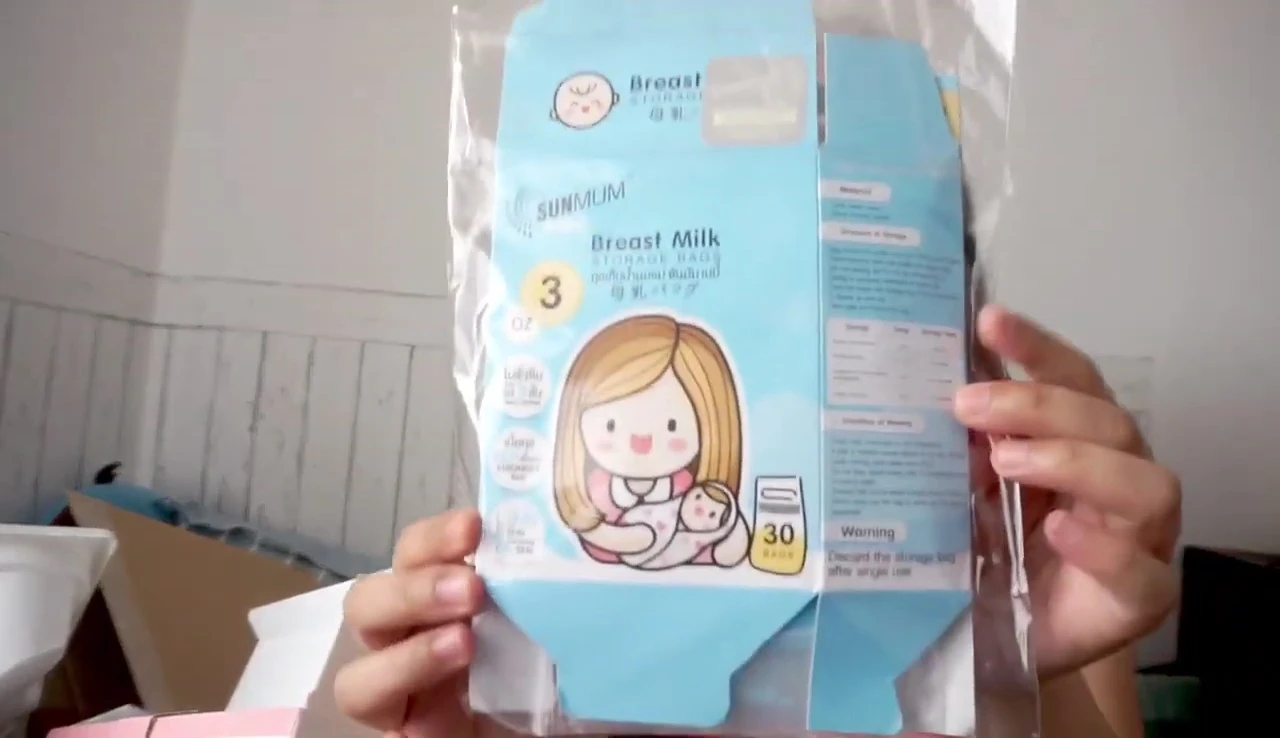 The reviewer displays the packaging of the milk storage bags once more.