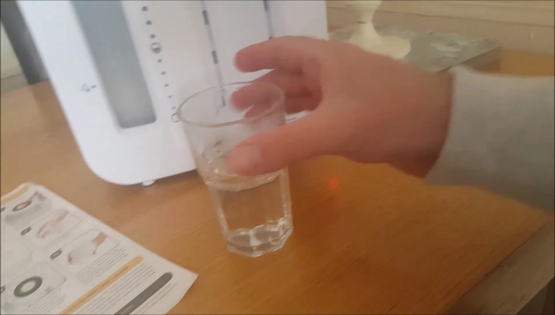 Final shot showing the machine in use and a prepared bottle of formula.