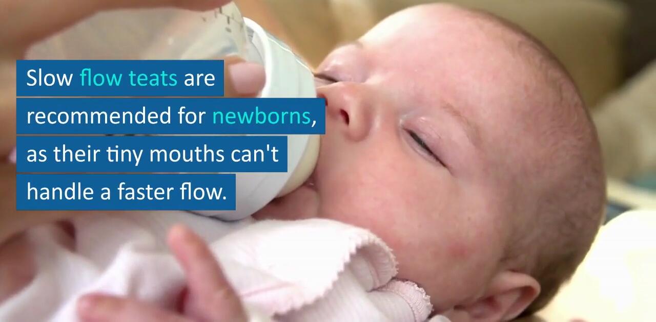 A baby comfortably feeding from a slow-flow bottle teat.