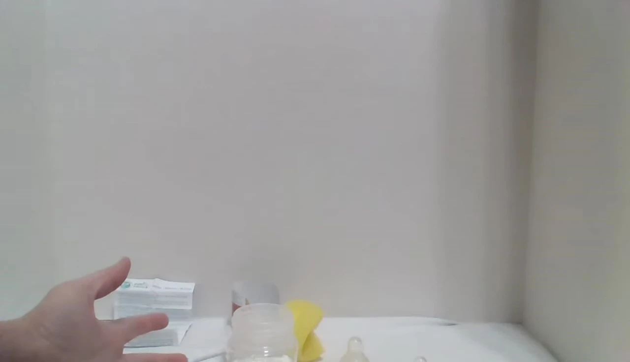 The reviewer showing the bottle and explaining the convenience of its size